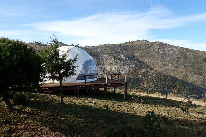 A glamping tent surrounded by nature