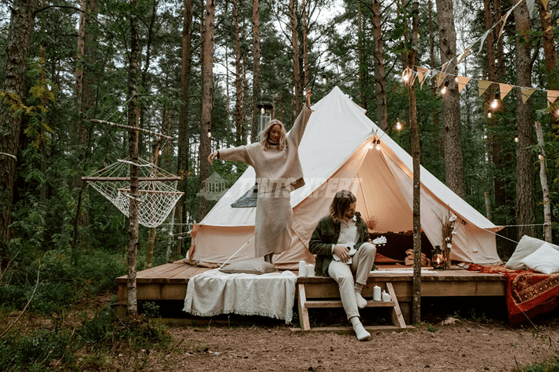 A couple dancing and playing an instrument in a forest